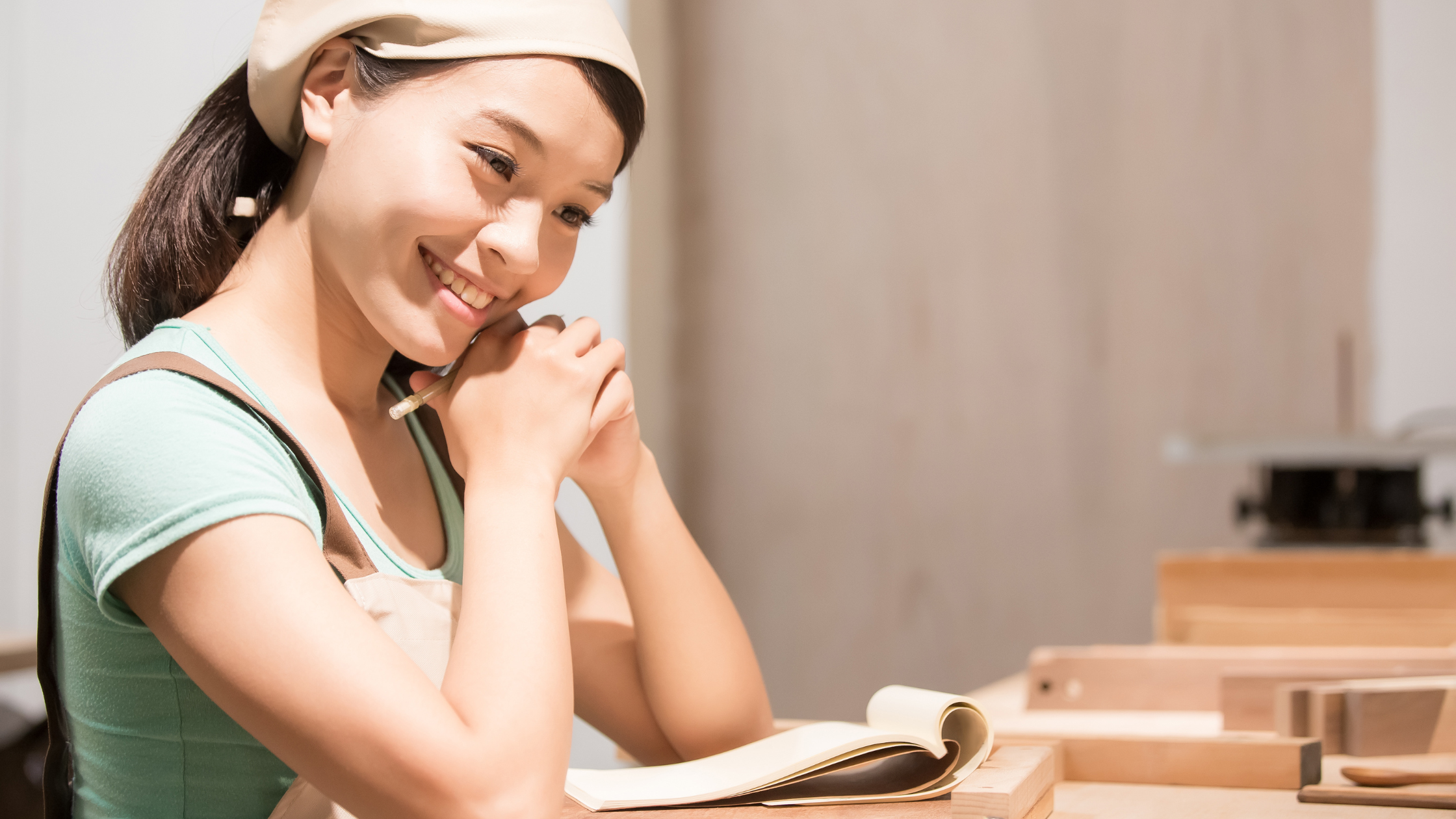 an asian professional woman in her at-home clothing thinking happily for the future ahead. an asian professional woman in her at-home clothing thinking happily for the future ahead.