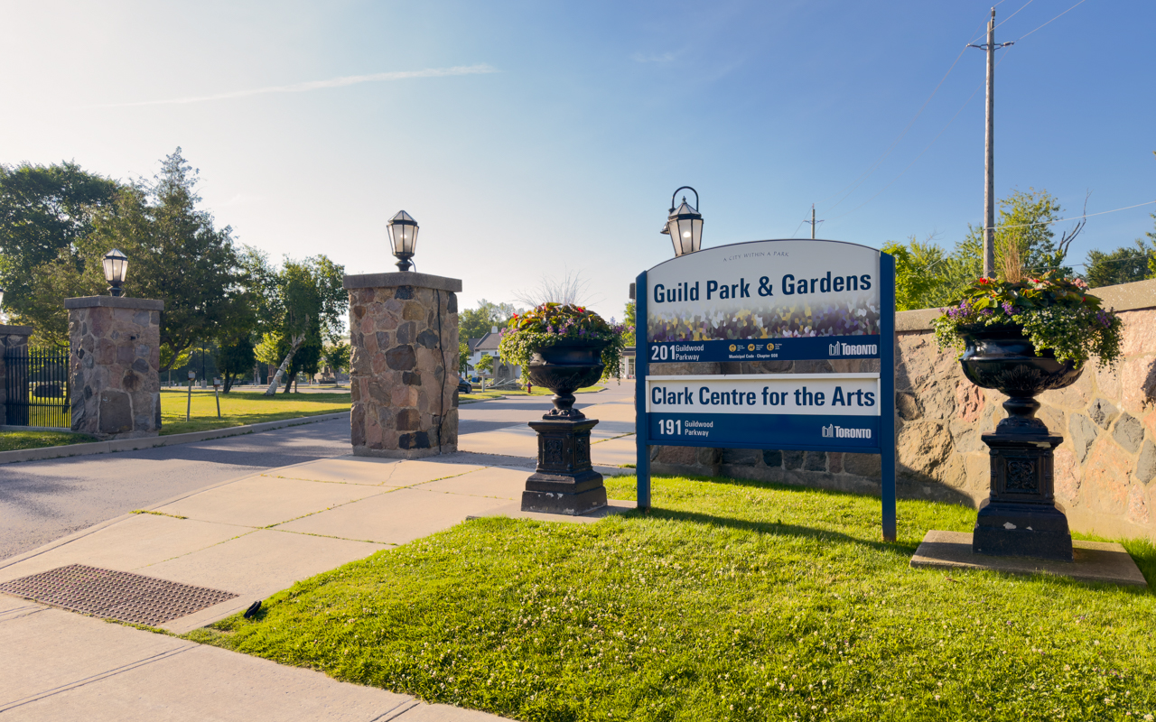 Guild Park & Gardens entrance sign on Guildwood Parkway in Scarborough Toronto, featuring stone pillars with lanterns and decorative planters at the historic sculpture park. Image courtesy: City of Toronto