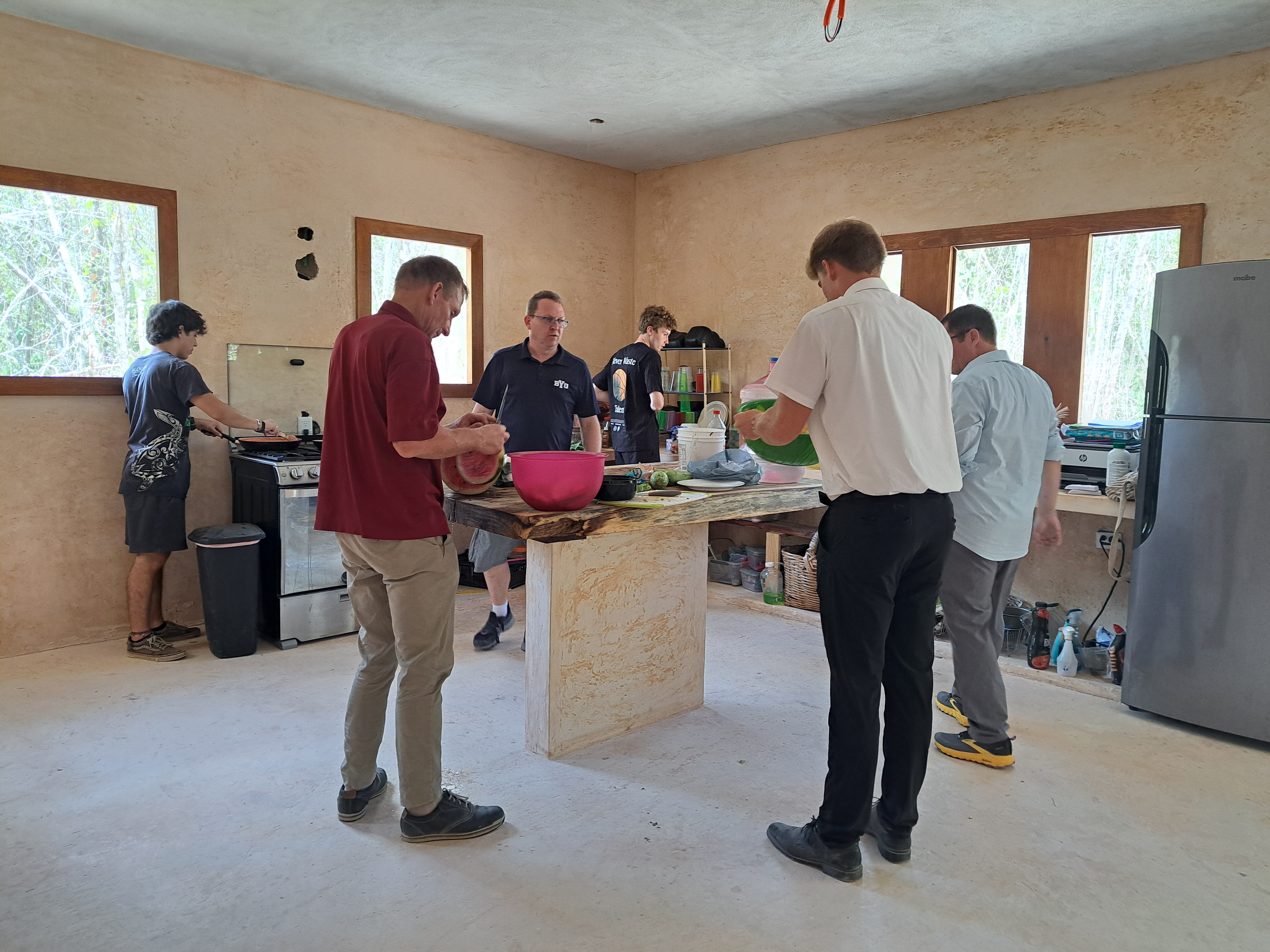 men cooking dinner during service trip