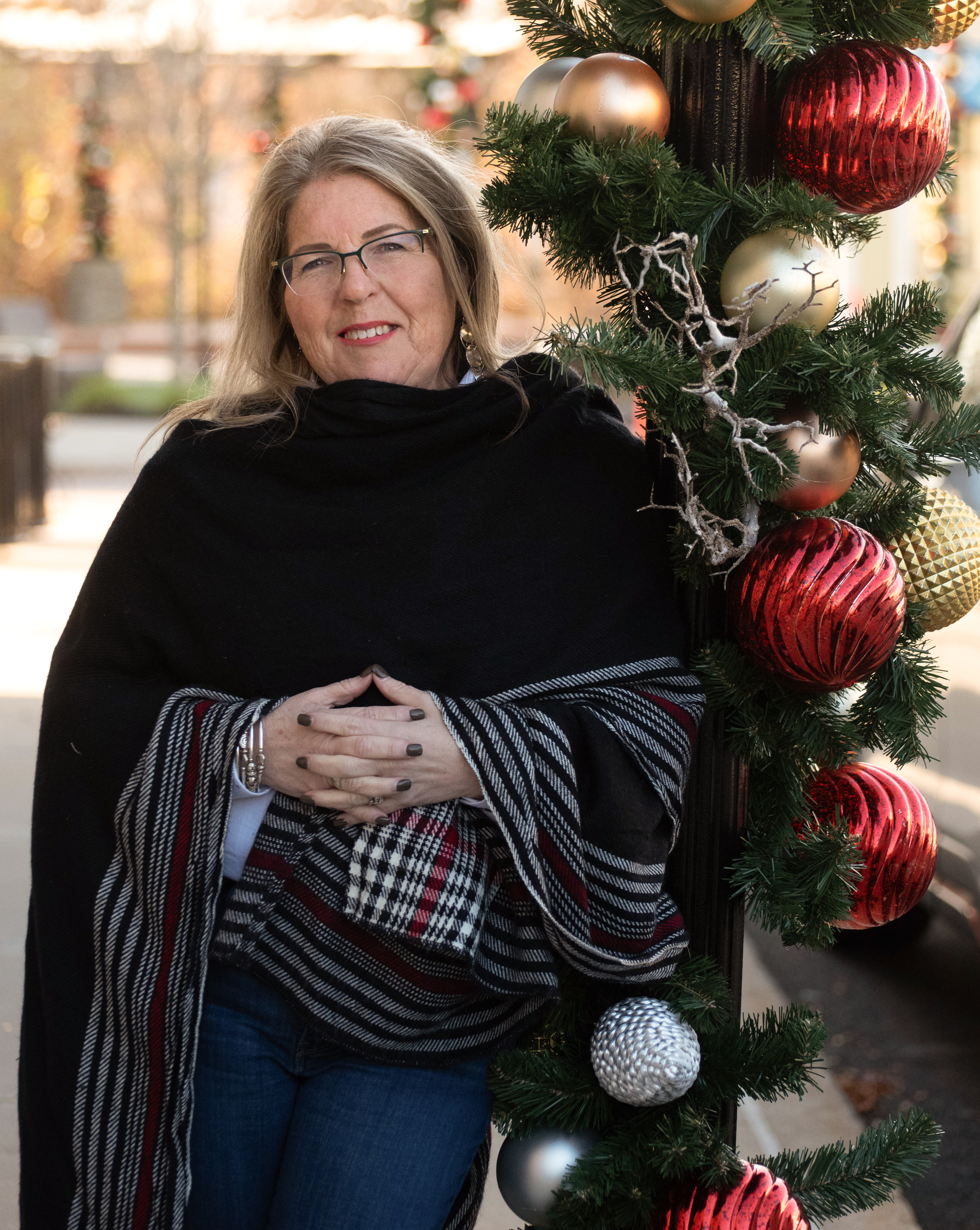 Auto Immune Coach Annmarie infront of Christmas tree 