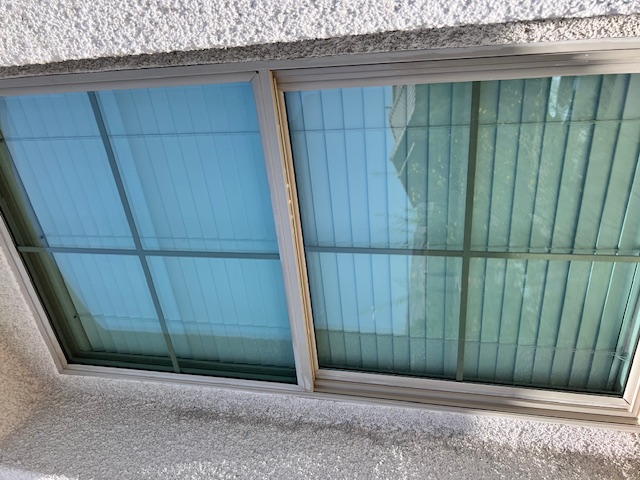 Close-up of a Las Vegas residential window with hard water stains forming around the edges Close-up of a Las Vegas residential window with hard water stains forming around the edges