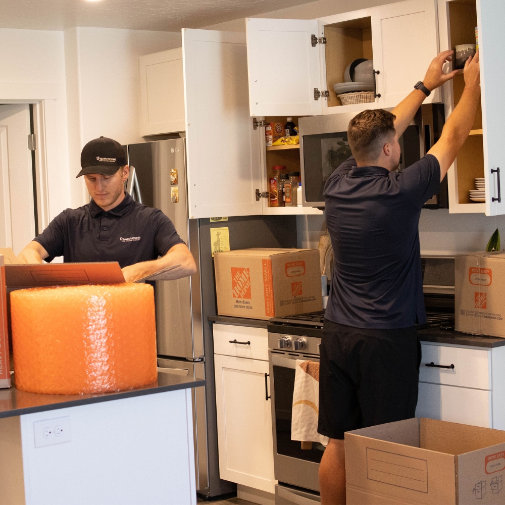 Professional movers packing boxes