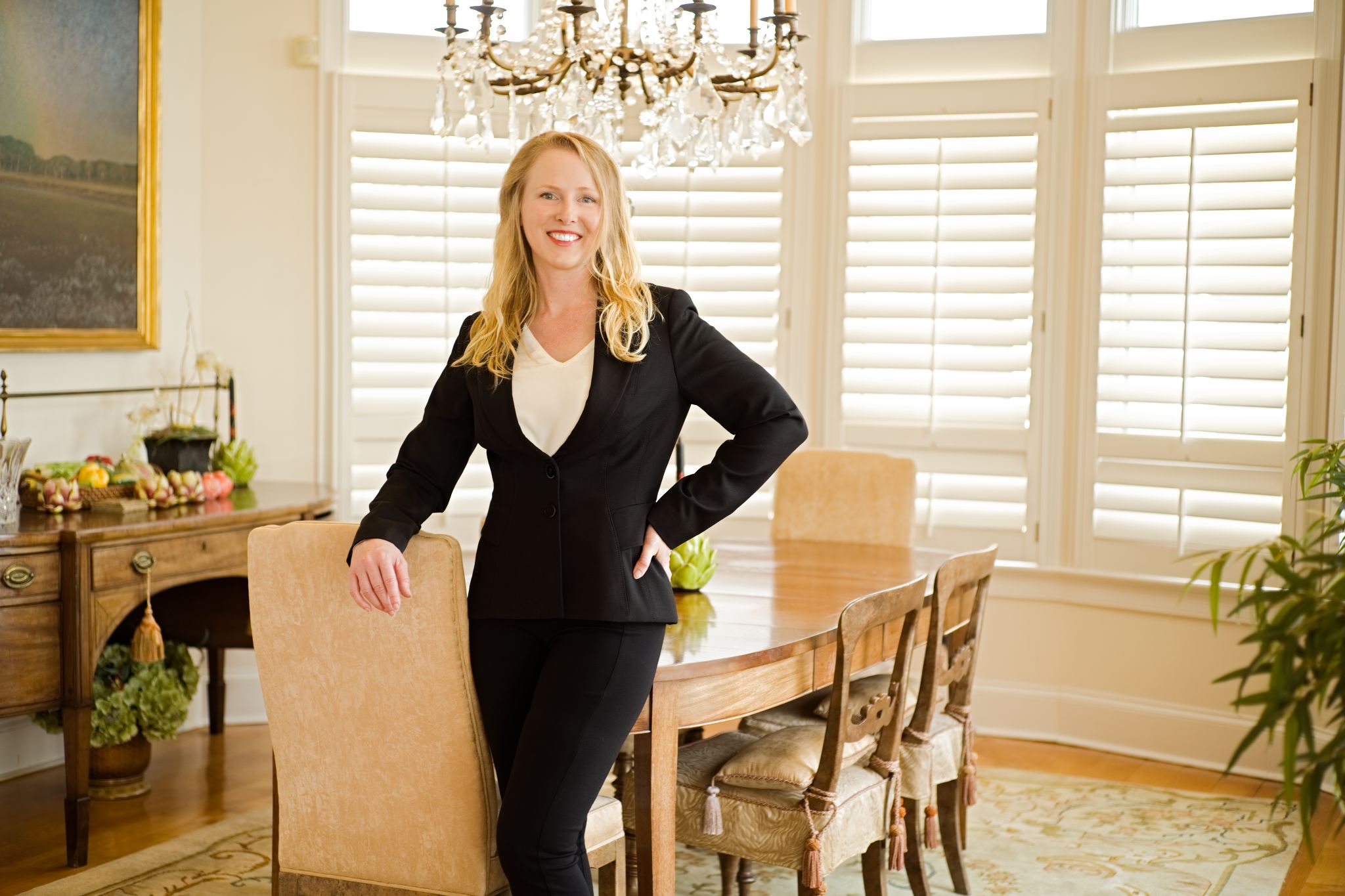 Bright and approachable headshot of a Charleston realtor with long blonde hair and a warm expression