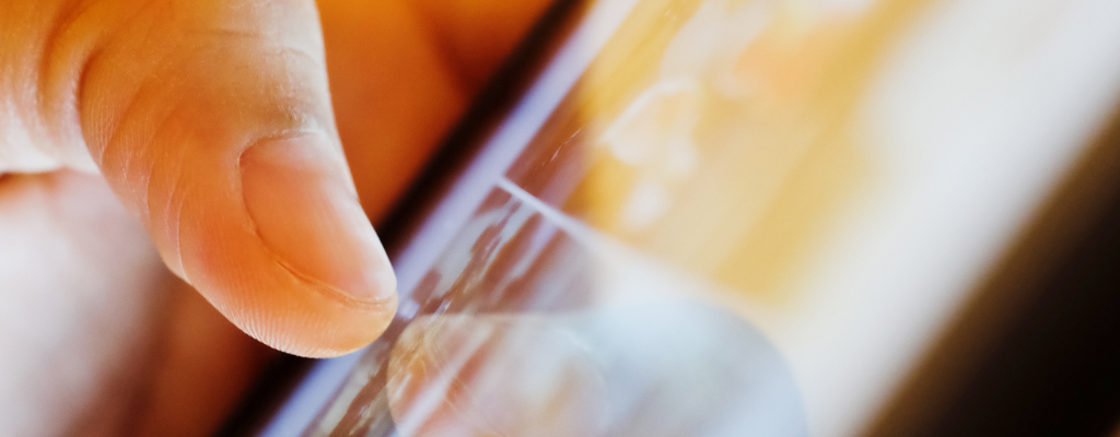 Thumb tapping phone screen up close. Thumb tapping phone screen up close.