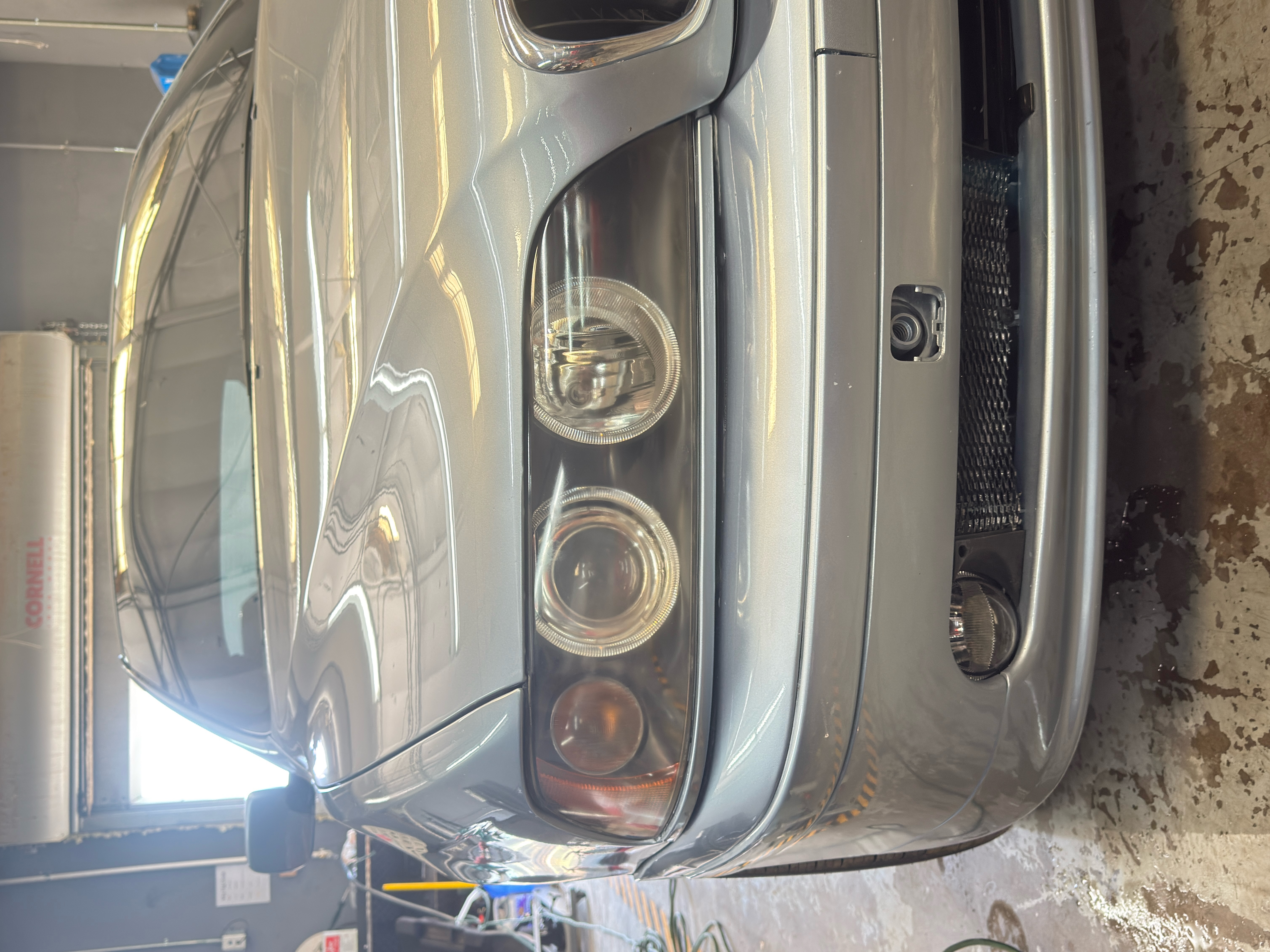 "Technician at RND Auto Detailing and Glass Repair restoring a vehicle's headlights, showcasing the transformation from cloudy to clear." "Technician at RND Auto Detailing and Glass Repair restoring a vehicle's headlights, showcasing the transformation from cloudy to clear."
