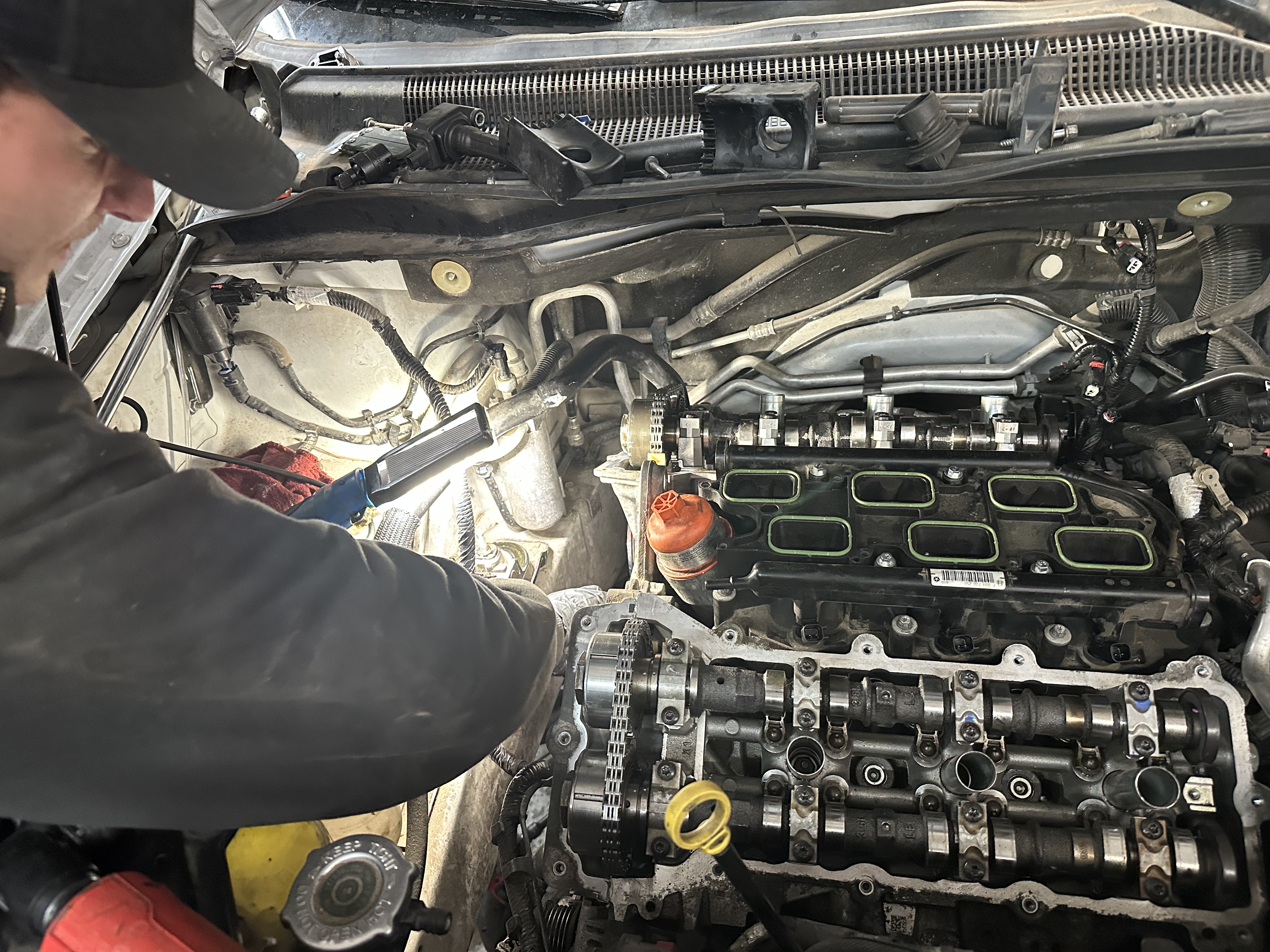 "An employee at Donny's Automotive LLC carefully working on a motor in the repair shop, showcasing attention to detail and expertise in automotive repairs." "An employee at Donny's Automotive LLC carefully working on a motor in the repair shop, showcasing attention to detail and expertise in automotive repairs."