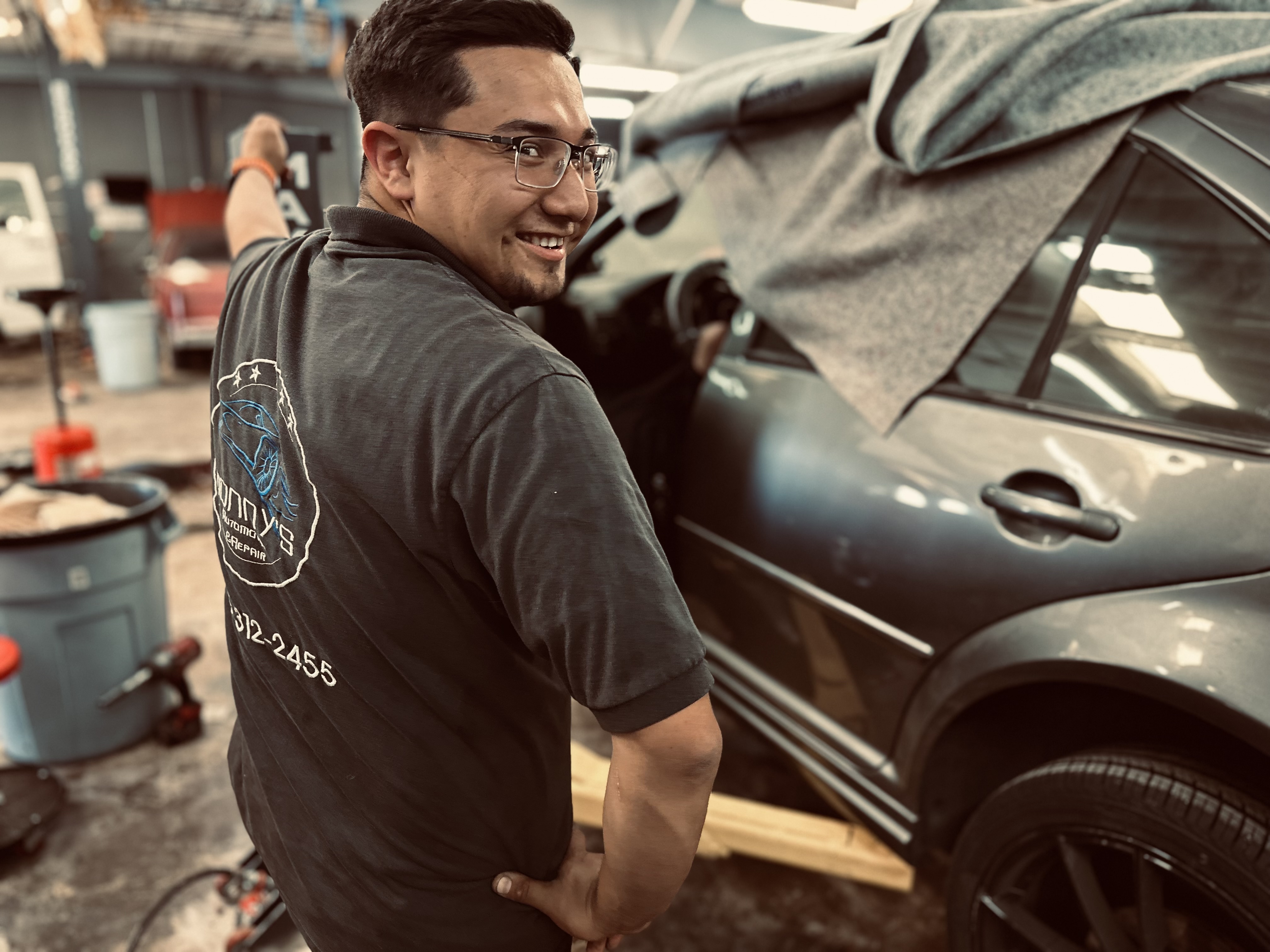 "An employee at Donny's Automotive LLC carefully working on a motor in the repair shop, showcasing attention to detail and expertise in automotive repairs." "An employee at Donny's Automotive LLC carefully working on a motor in the repair shop, showcasing attention to detail and expertise in automotive repairs."