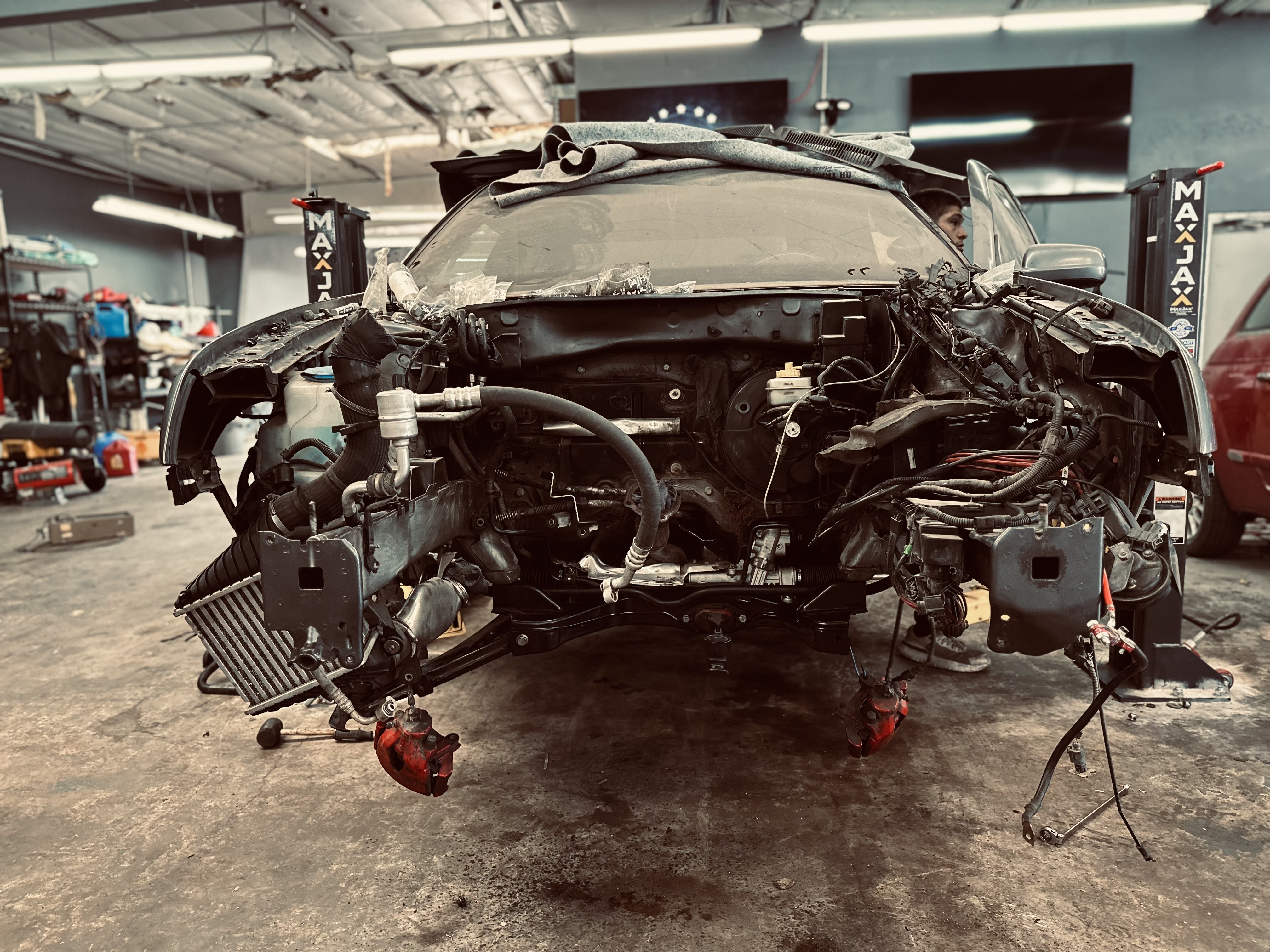 “Remanufactured engine on a hoist, prepared for installation during a motor swap at Donny’s Automotive.” “Remanufactured engine on a hoist, prepared for installation during a motor swap at Donny’s Automotive.”