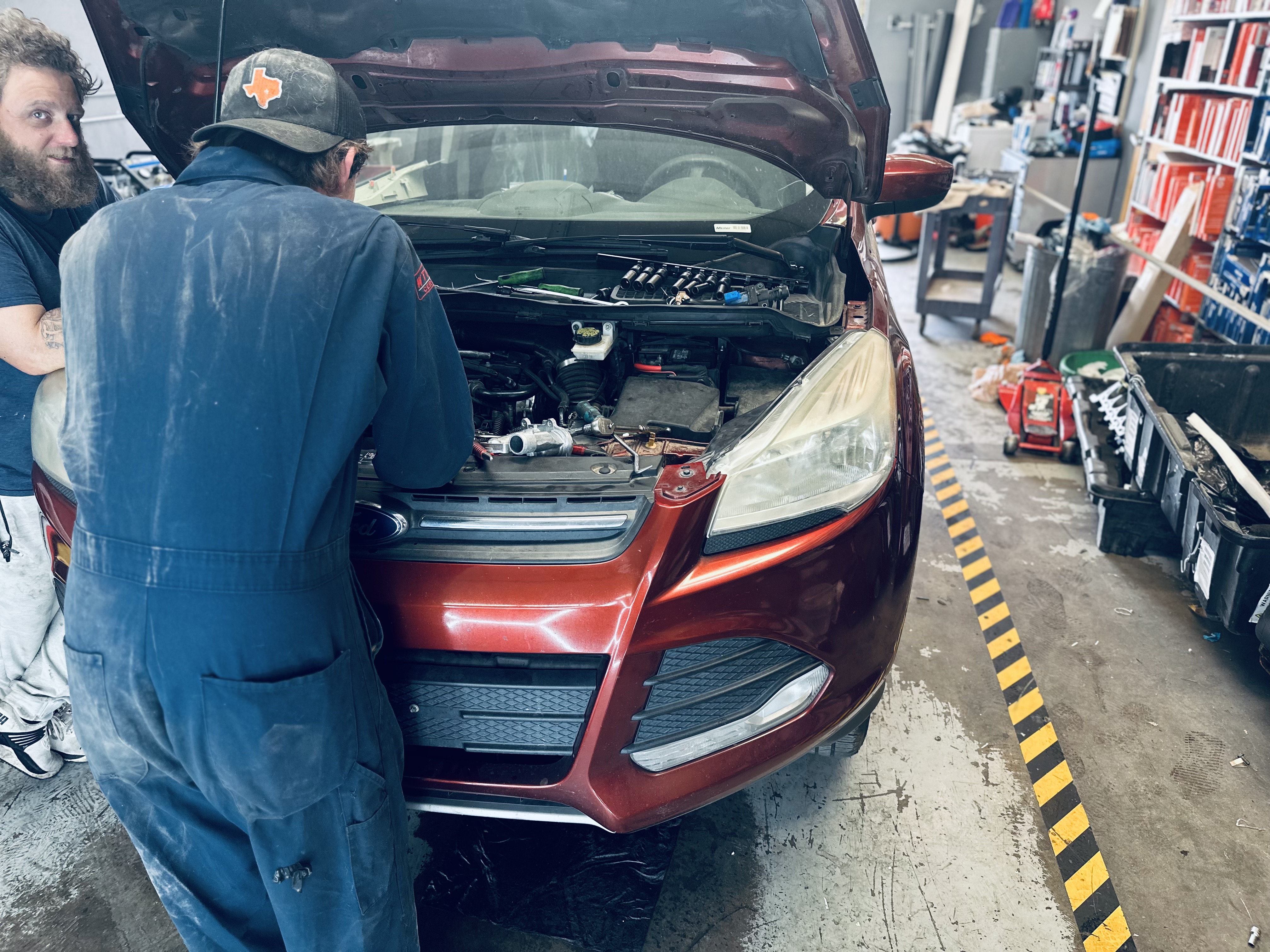 An ASE-certified technician uses diagnostic equipment under the hood of a car, with tools and a checklist nearby in the Donny’s Automotive garage. An ASE-certified technician uses diagnostic equipment under the hood of a car, with tools and a checklist nearby in the Donny’s Automotive garage.