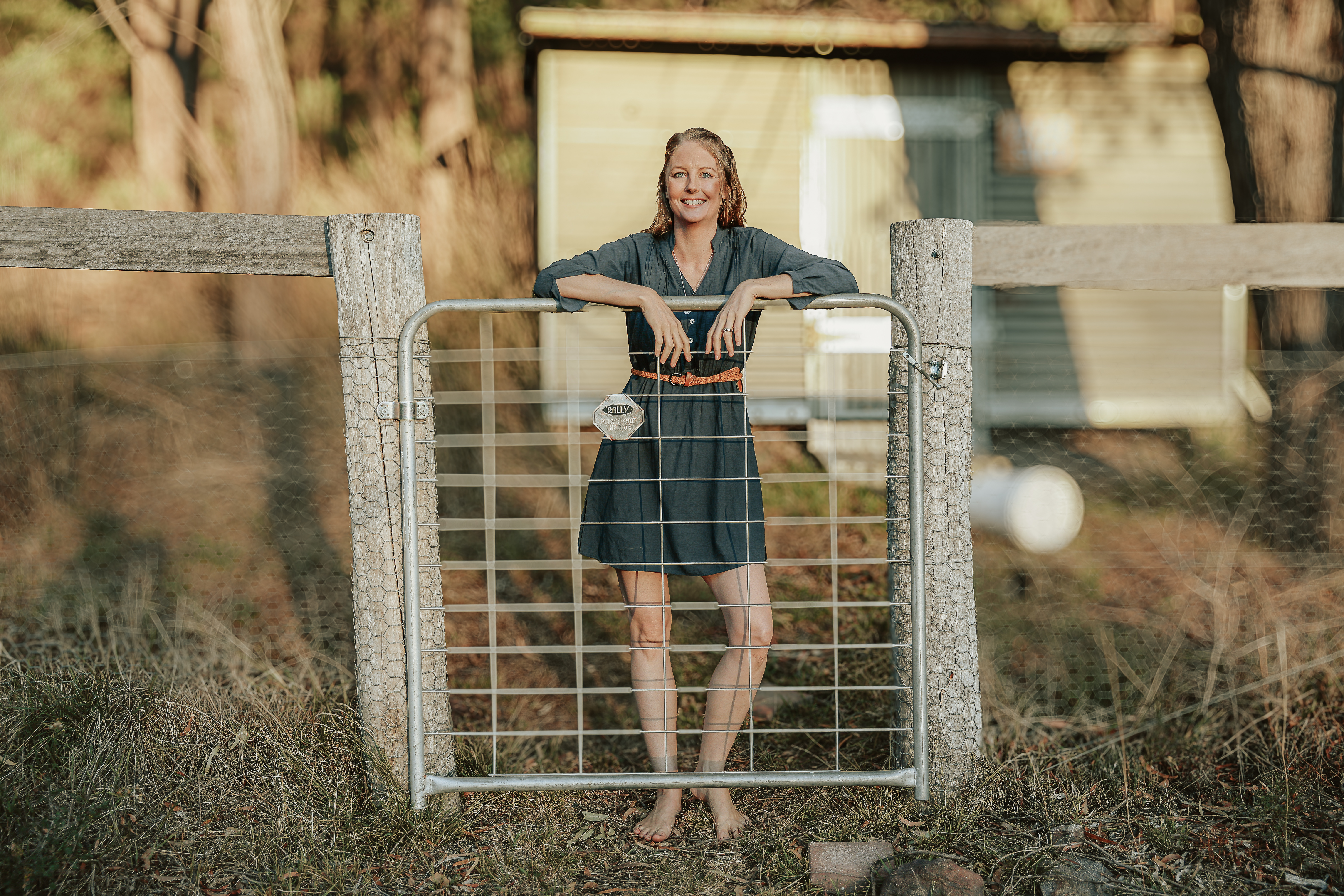 Zoe standing at a gate smiling, holding a strong boundary Zoe standing at a gate smiling, holding a strong boundary