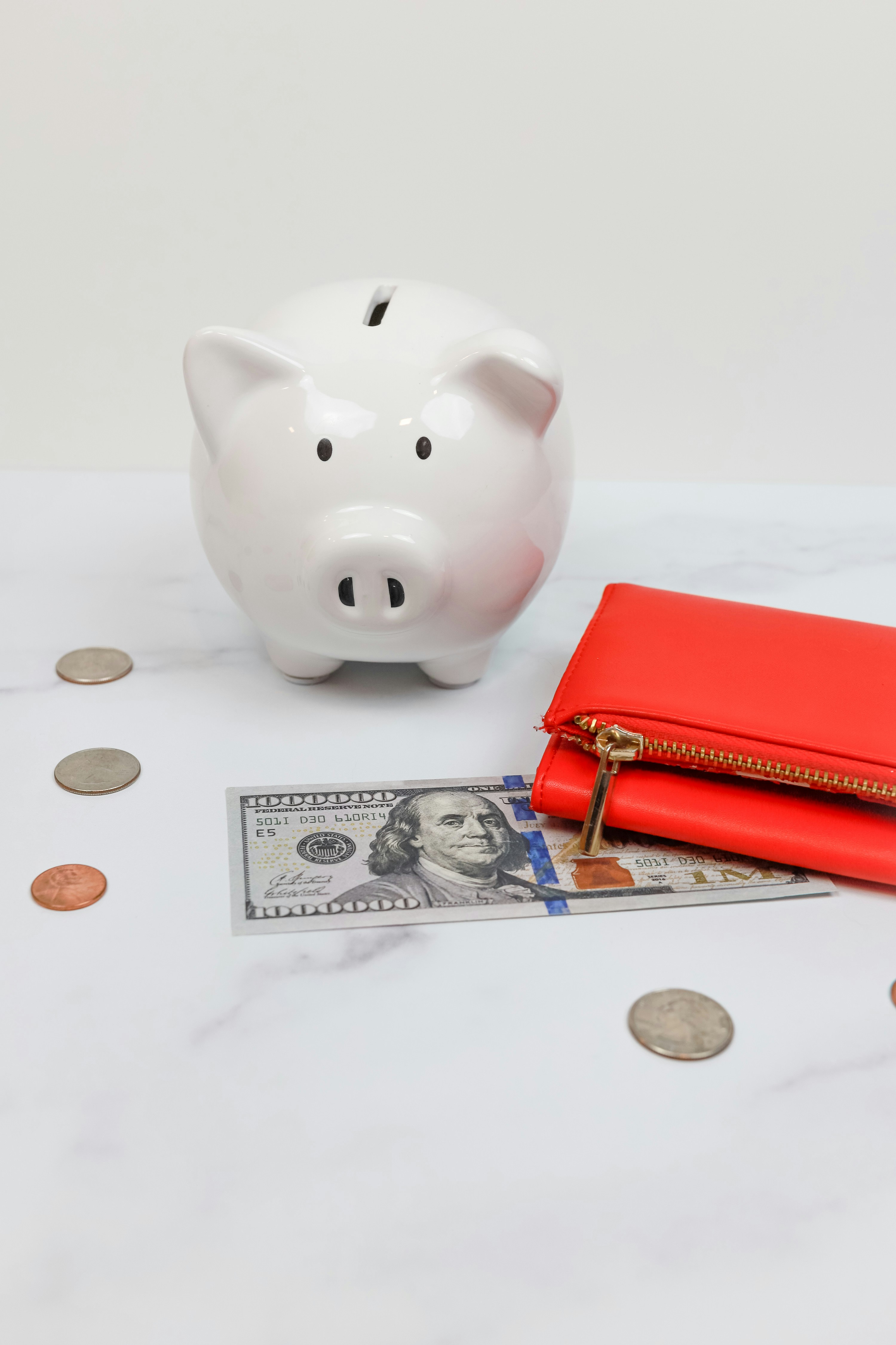 money and coins on table with piggy bank
