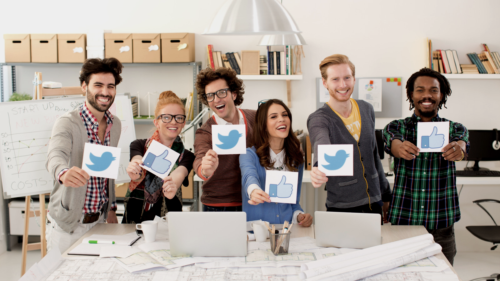 happy people holding signs with Twitter logo