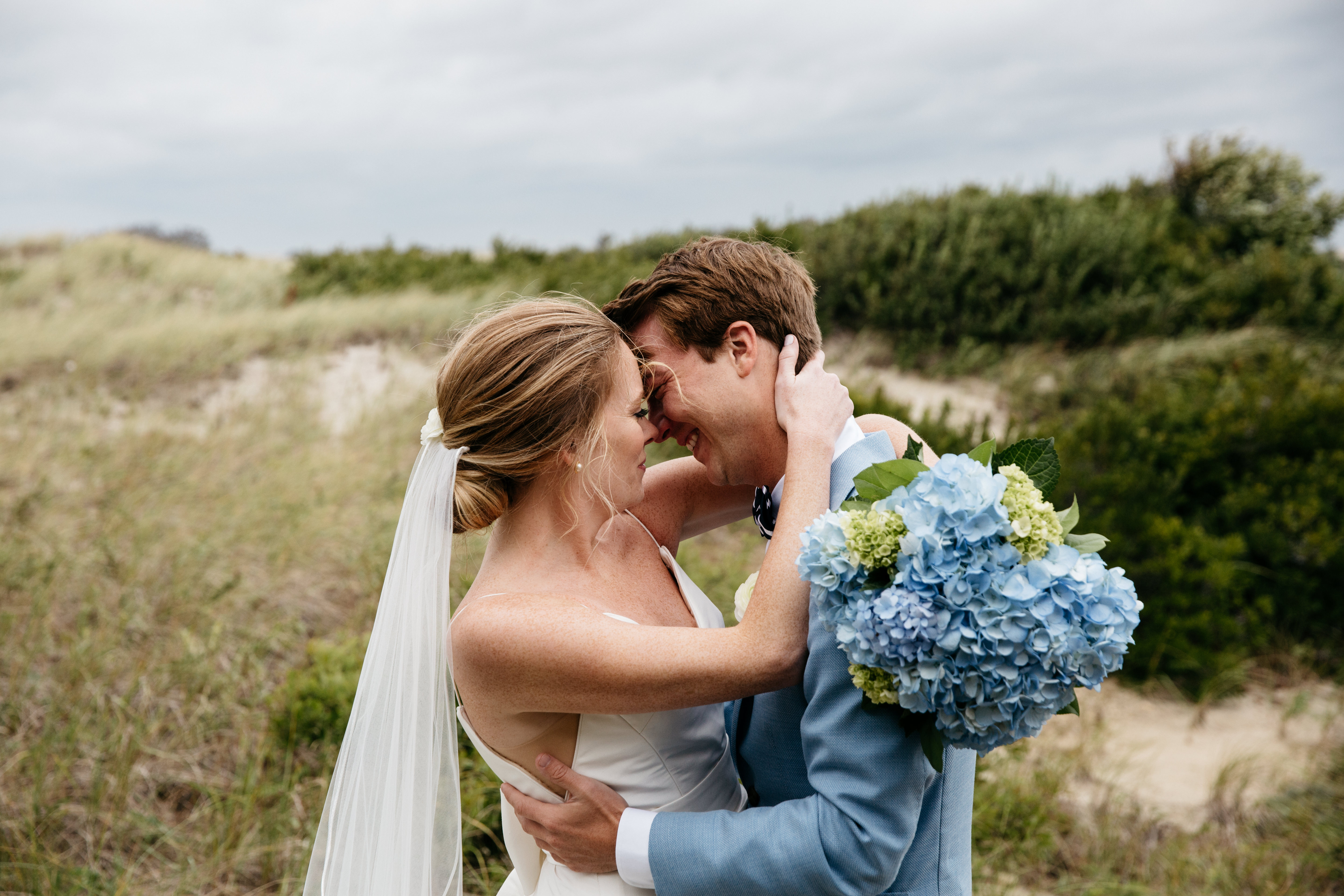 couple embracing on cape cod beach man is crying