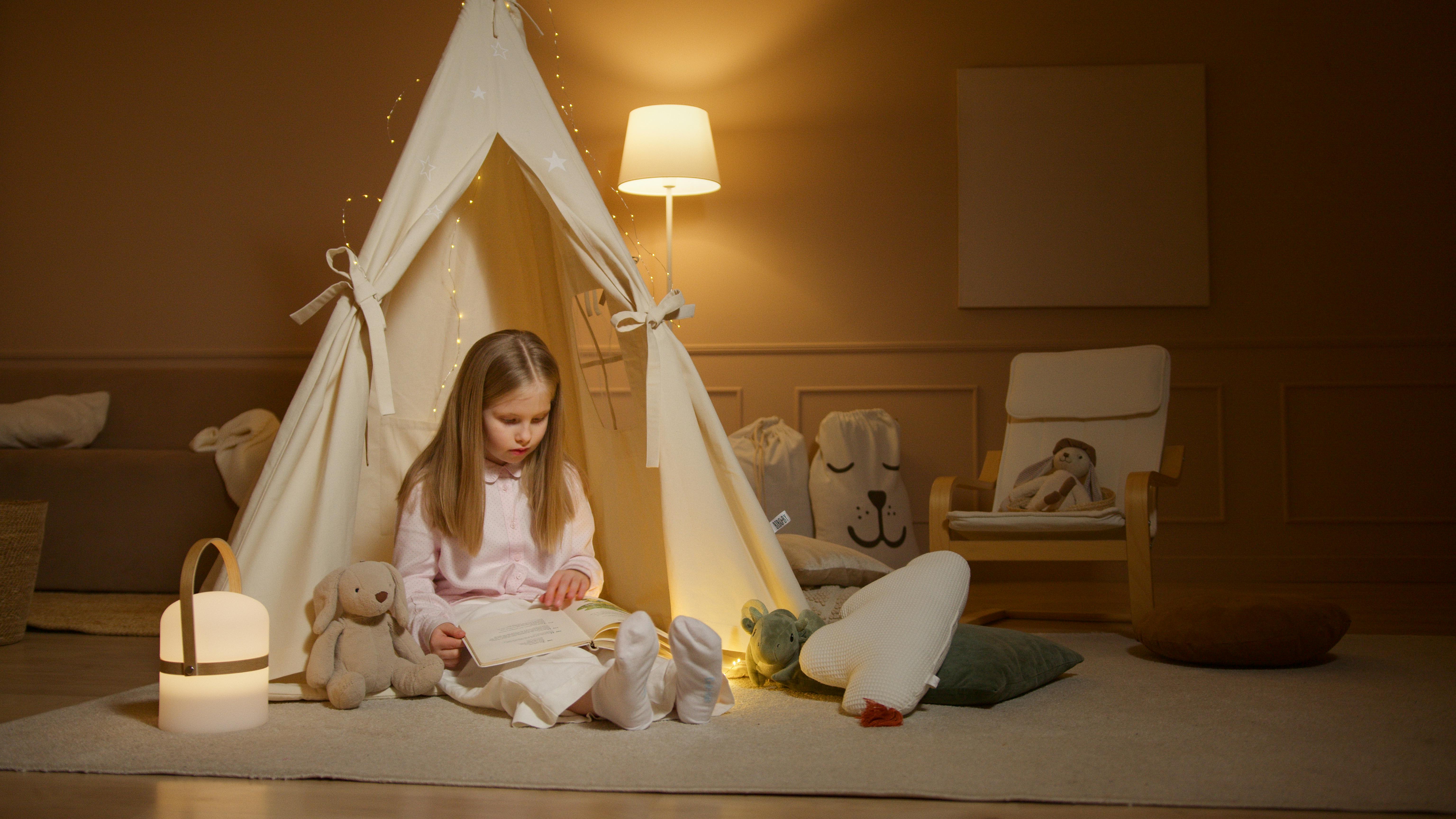 little girl reading in a tent in her room. Making reading fun little girl reading in a tent in her room. Making reading fun