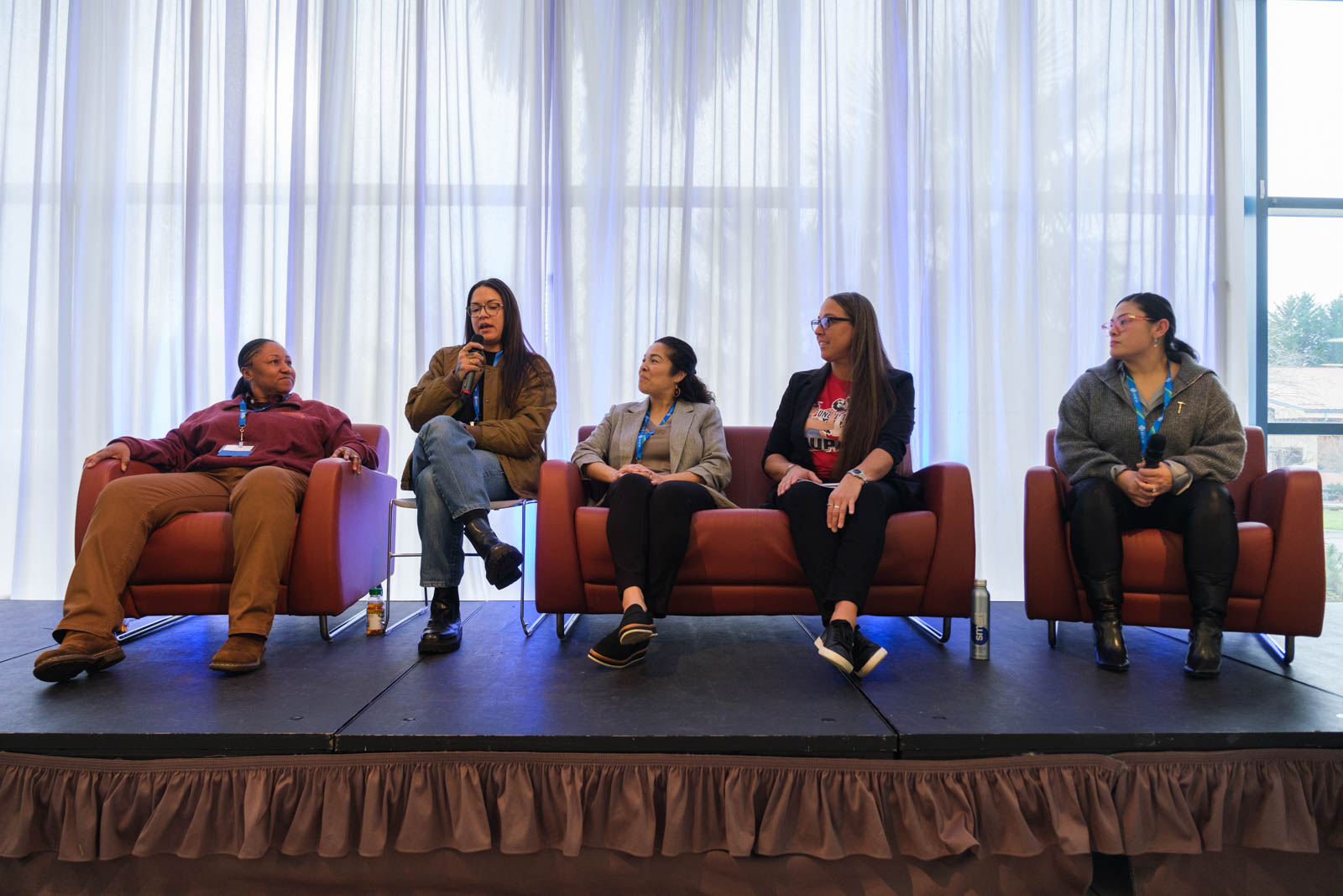 A group of people sitting on stage.