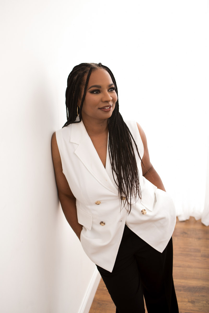 Headshot of Charleen in a white suit by Cory Powell Photography
