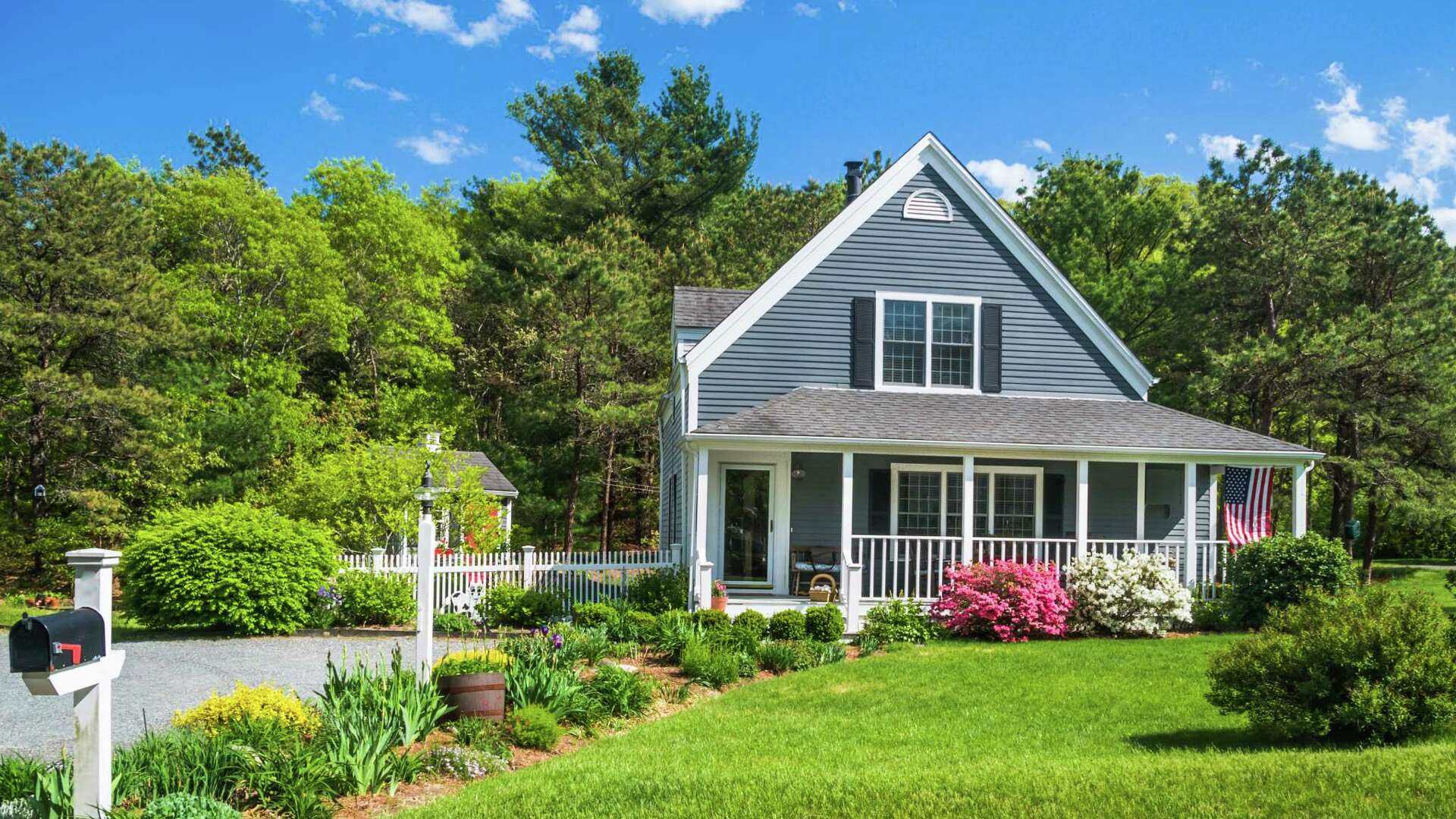 A welcoming home surrounded by mature green trees