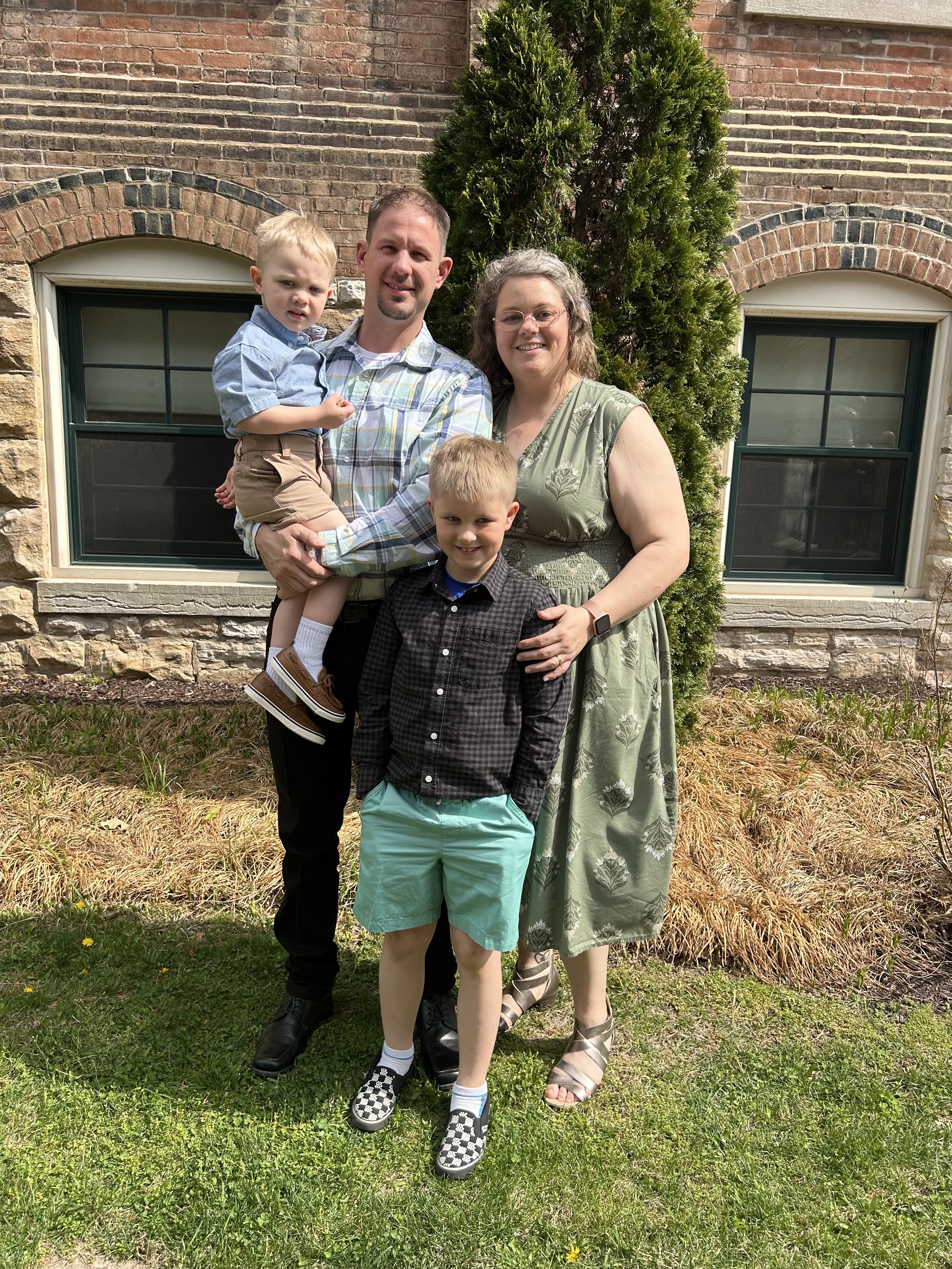 Nick and Amanda, founders of Just Horsin Around Acres, with their children Eddie and Teddy at their Millersburg Missouri farm