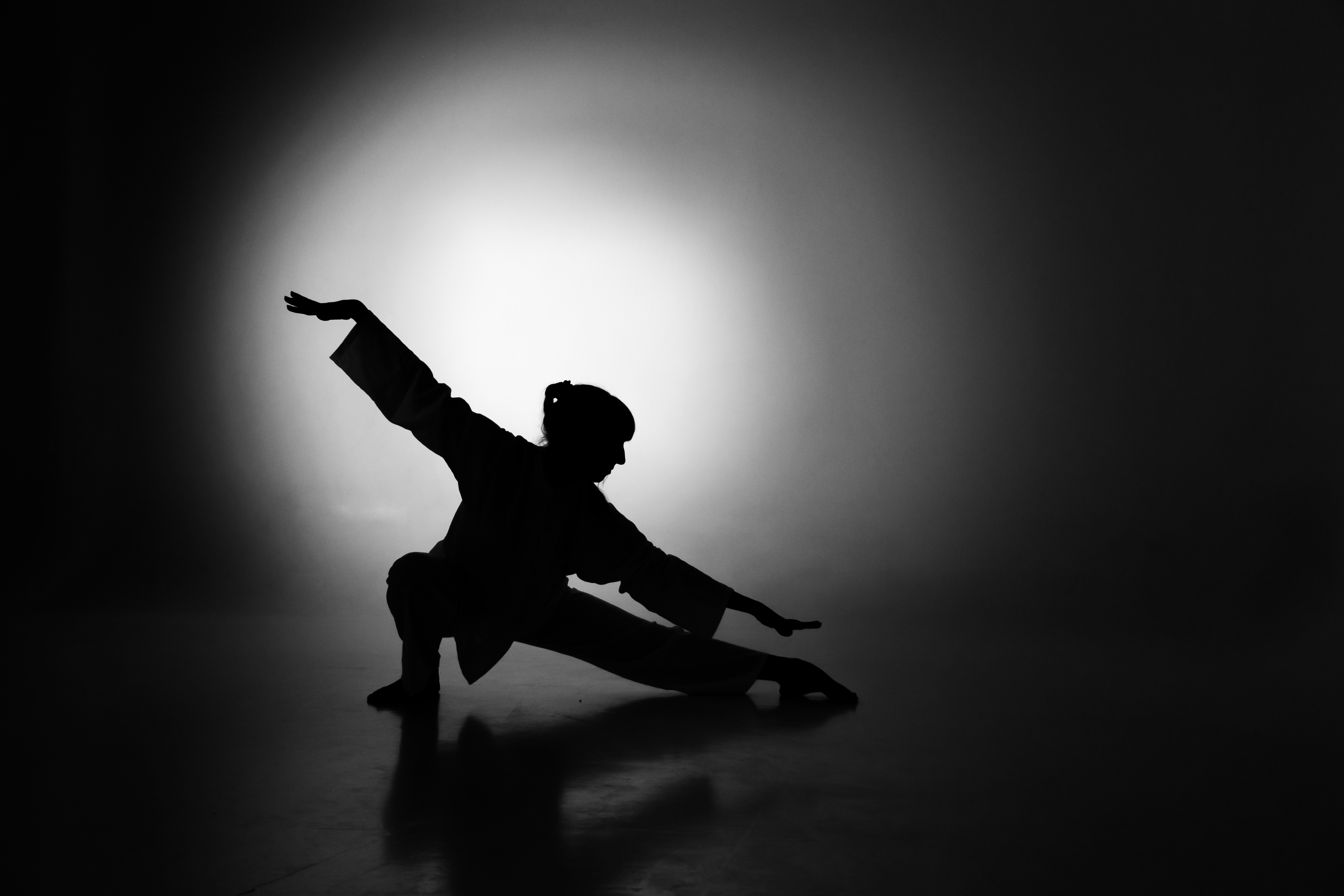 Person in a graceful, flowing movement pose.