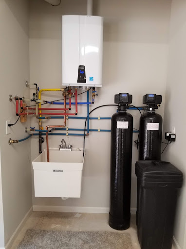 Newly installed water softener system in a residential setting, designed to remove minerals and provide soft water, enhancing appliance efficiency and improving skin and hair health.