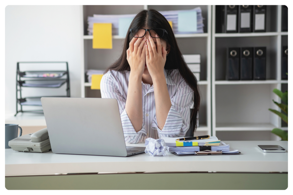 Sitting at desk overwhelmed Sitting at desk overwhelmed
