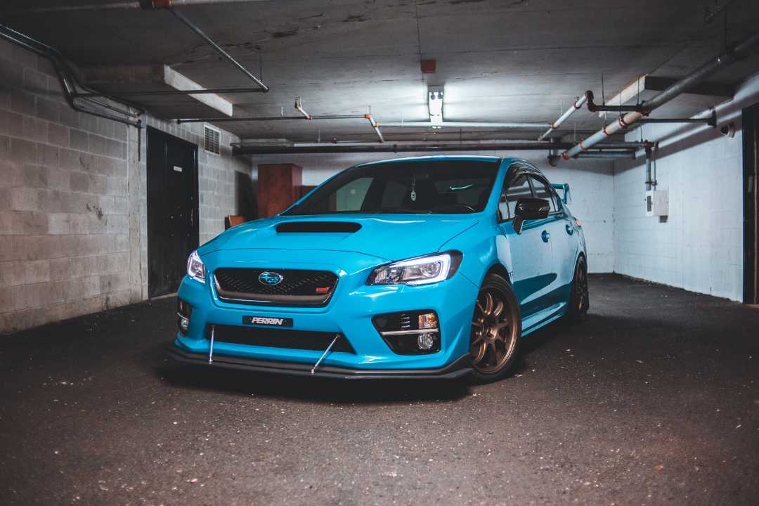 Bright blue performance car in basement parking, perfectly maintained and ready for official car title transfer Illinois paperwork.