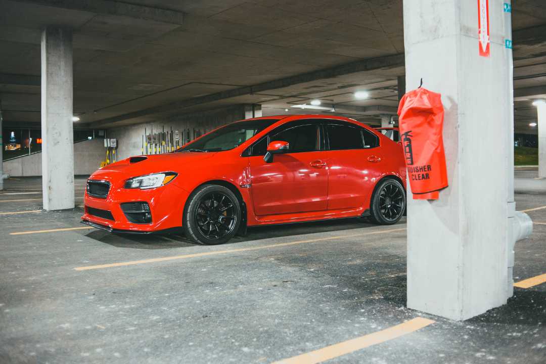 Shiny red car with black wheels in parking structure, illustrating expenses tied to Illinois vehicle tax, title, and license costs. Shiny red car with black wheels in parking structure, illustrating expenses tied to Illinois vehicle tax, title, and license costs.