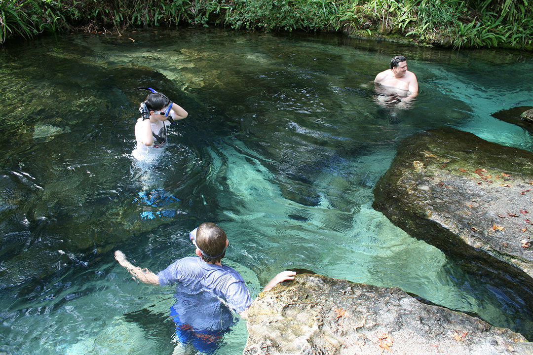 Three people are standing in the headwaters of Rock Springs. Three people are standing in the headwaters of Rock Springs.