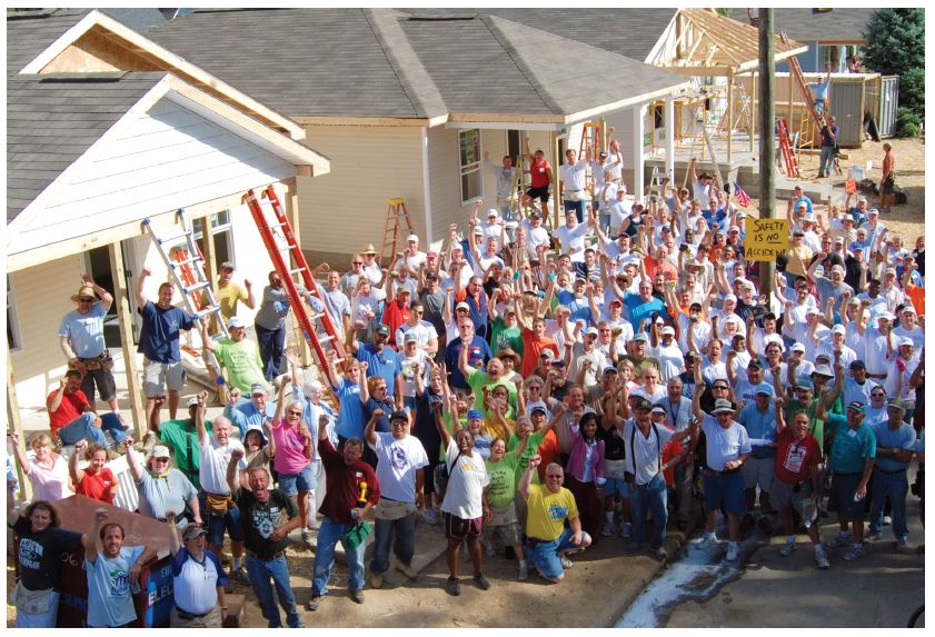 Volunteer group photo in front of neighborhood build project Volunteer group photo in front of neighborhood build project