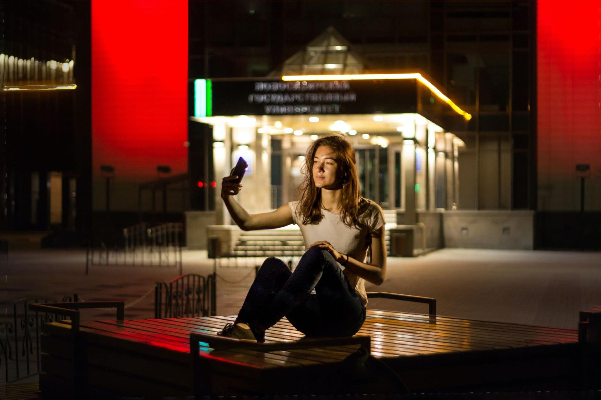 woman on table taking selfie for instagram