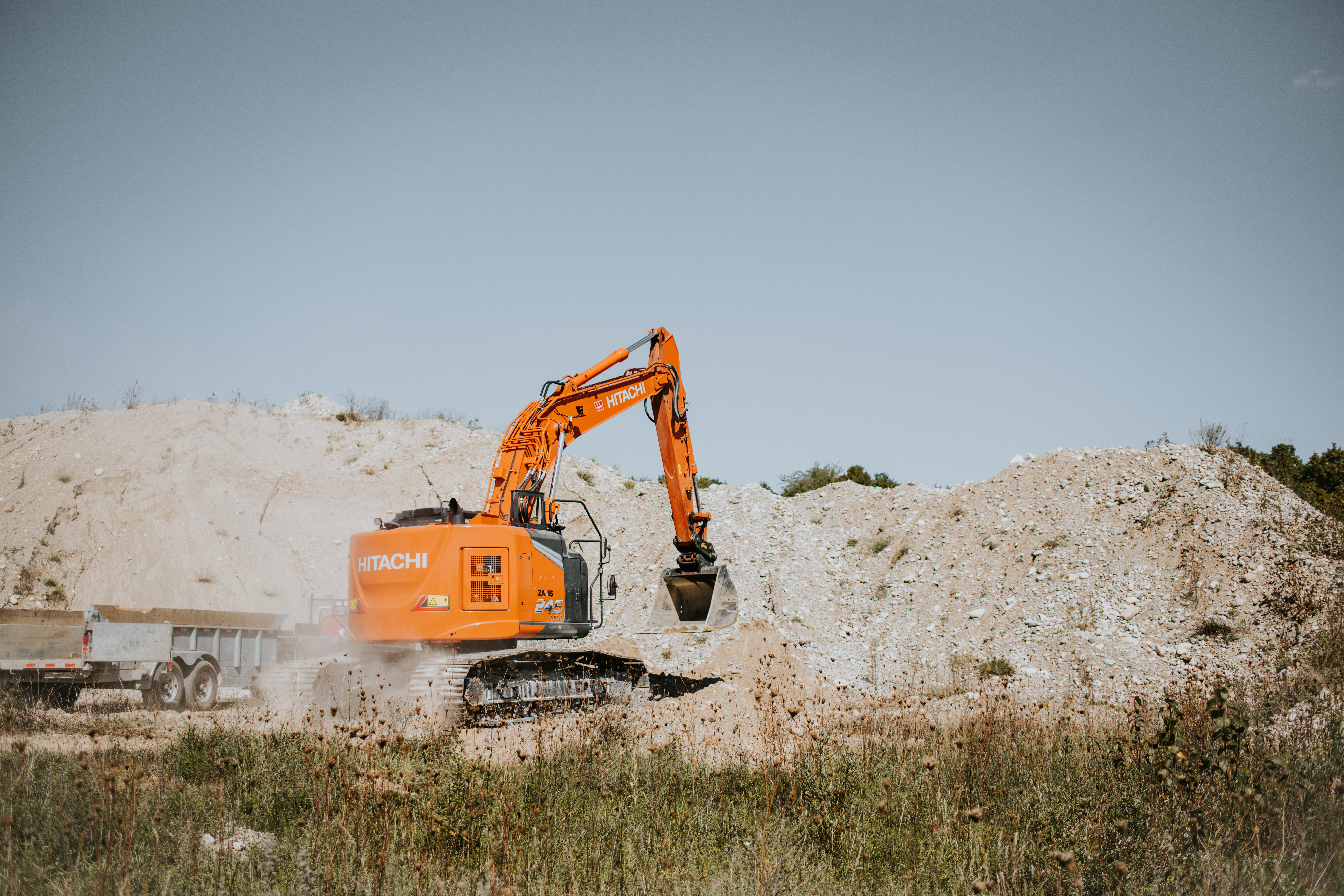 A backhoe doing a cut and fill