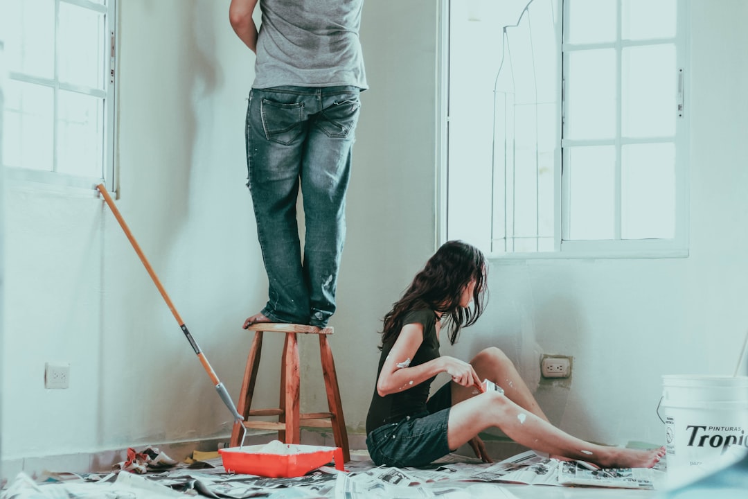 couple painting house diy