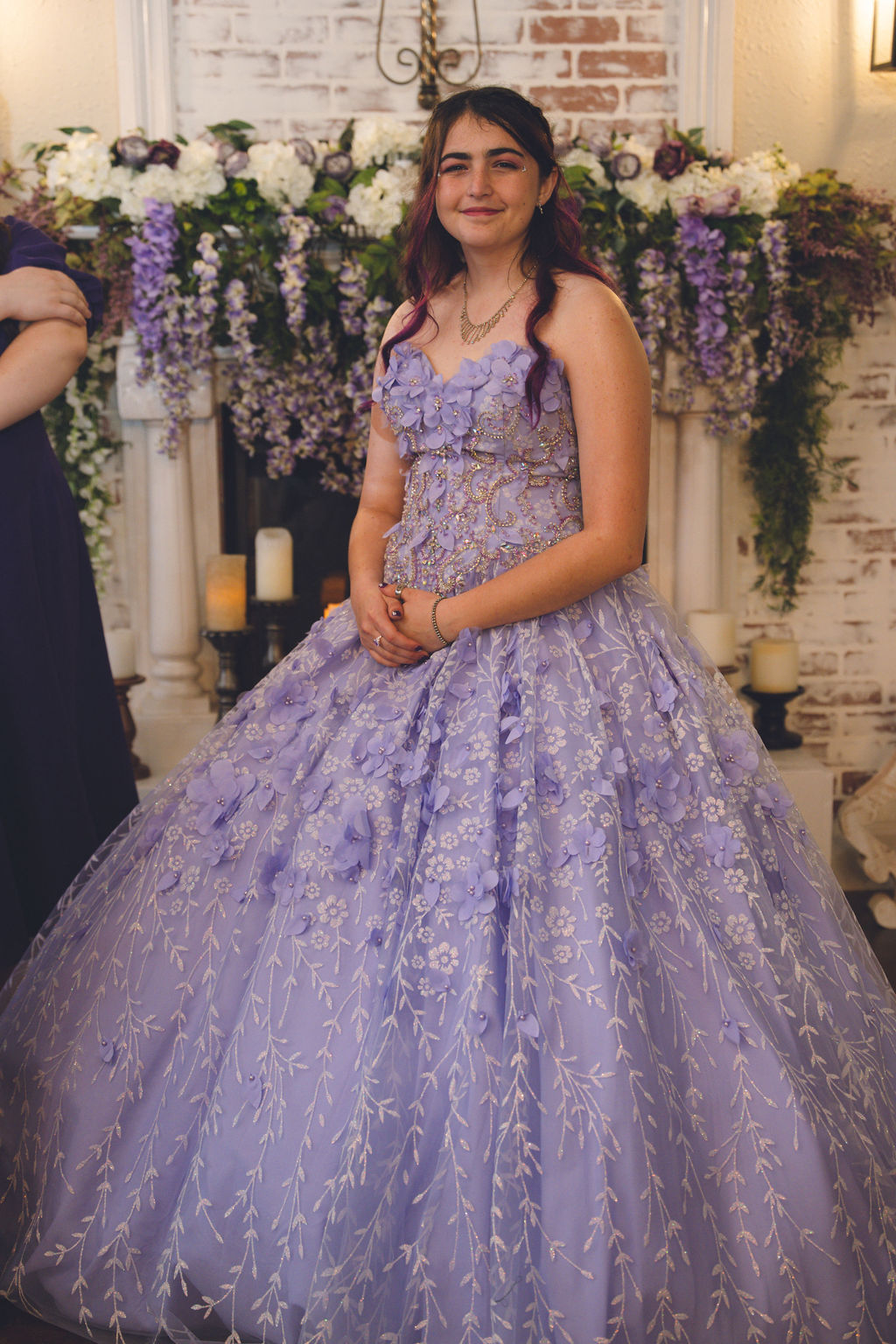 Iliana in her stunning light purple Alice in Wonderland quinceanera dress adorned with floral details, showcasing her magical quinceanera inspired by the Alice in Wonderland quince theme.