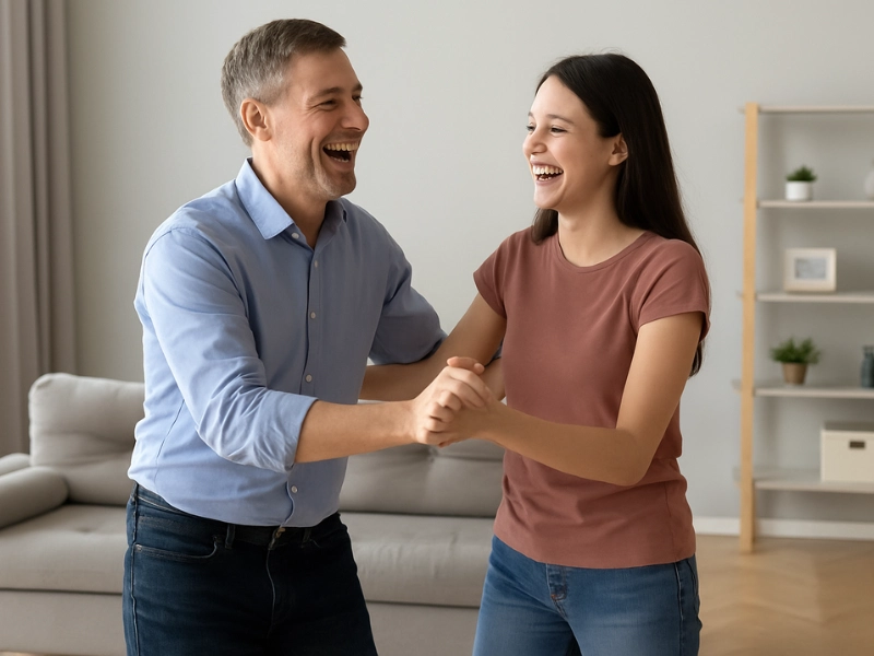 Father and daughter practicing their quinceañera dance at home, laughing and relaxed Father and daughter practicing their quinceañera dance at home, laughing and relaxed
