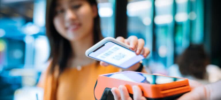 A smartphone scanning a QR code for event entry. A smartphone scanning a QR code for event entry.