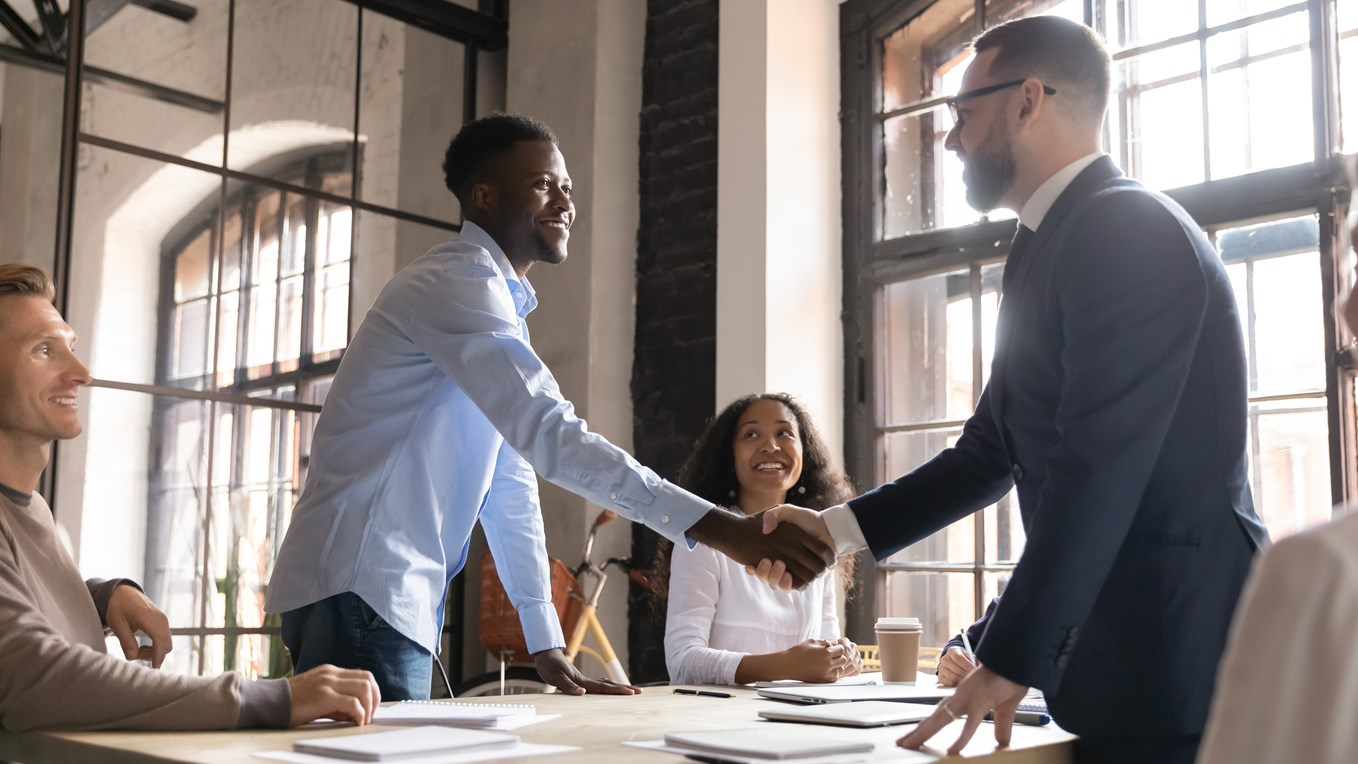 A handshake between a small business owner and a vendor. A handshake between a small business owner and a vendor.