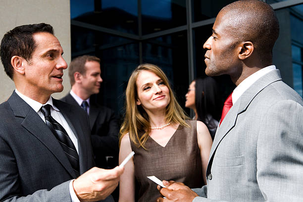 A group of professionals networking at a business event. A group of professionals networking at a business event.