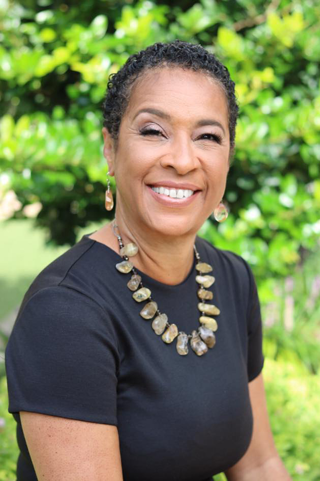 ladetra white smiling headshot in black blouse