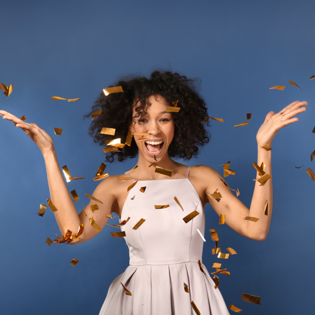 woman in white dress with gold confetti