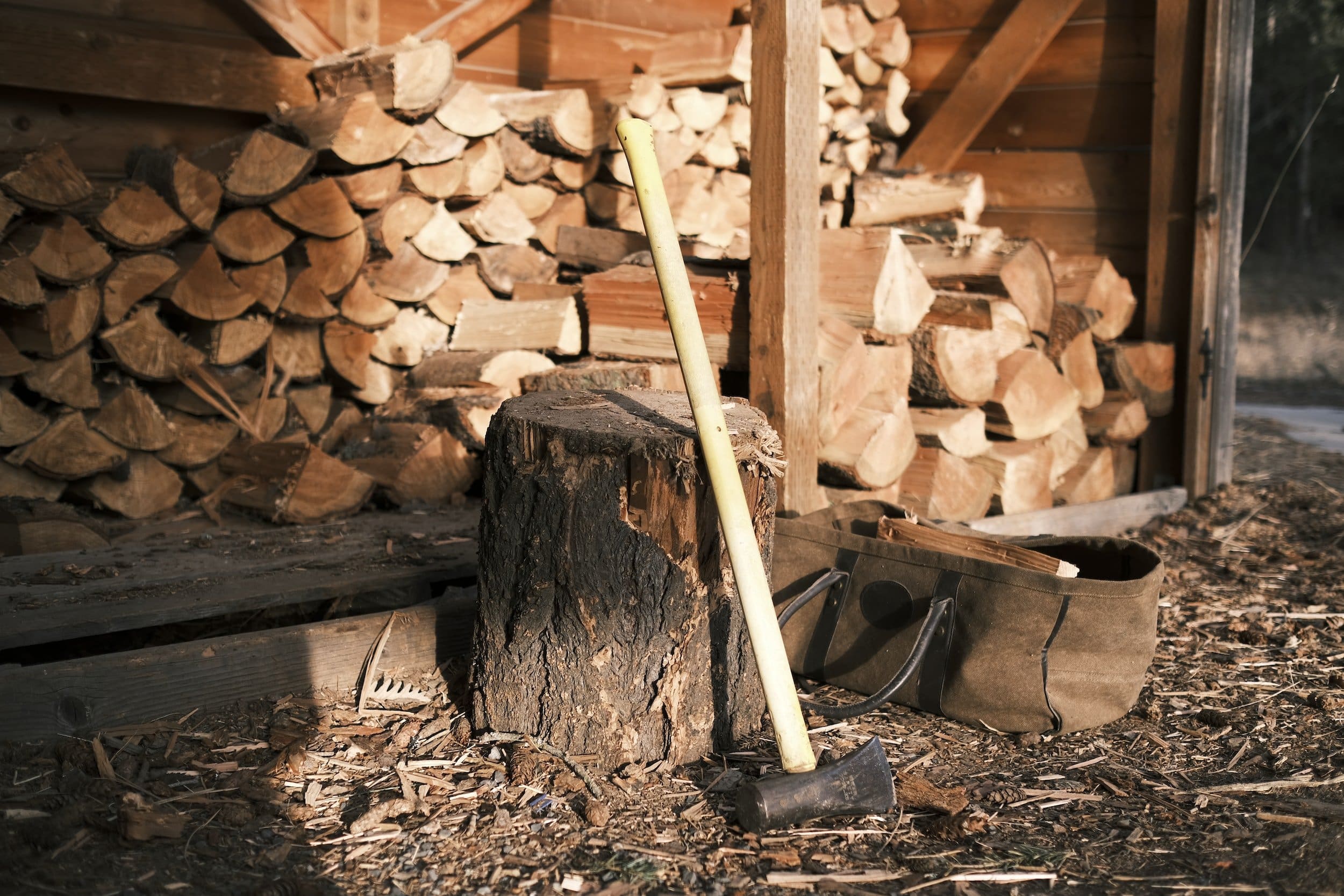 a woodpile with a wood and an axe