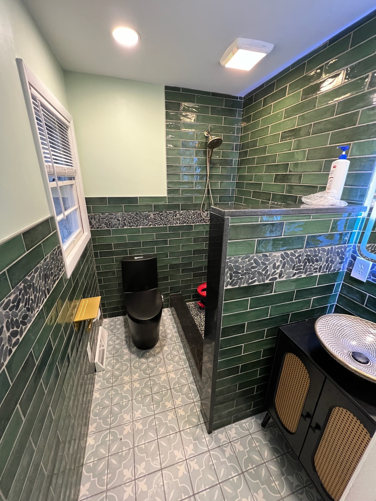 renovated bathroom with toilet, sink, new tiles