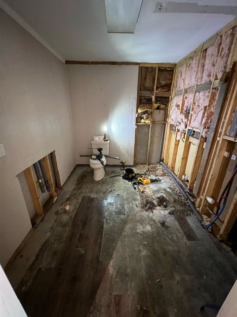 a bathroom with a toilet and tools