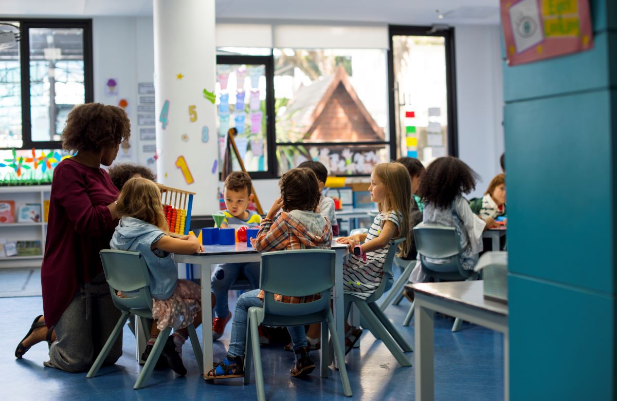 Smiling child in a group setting at daycare, fostering social interaction