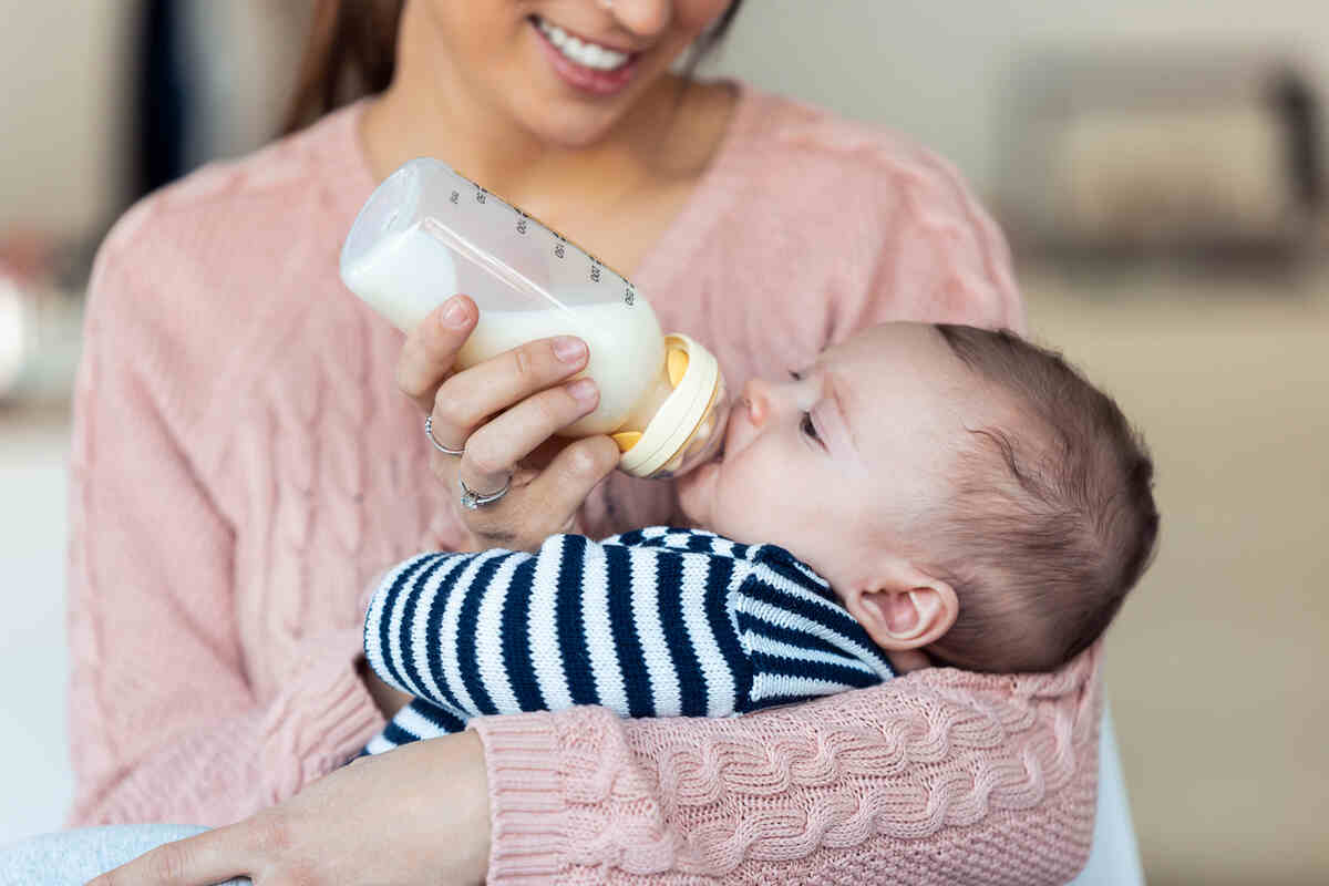 happy-young-mother-feeding-her-baby-son-infant-care