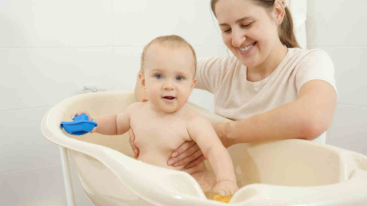 smiling-mother-holding-and-looking-at-her-baby-son-infant-care-tips