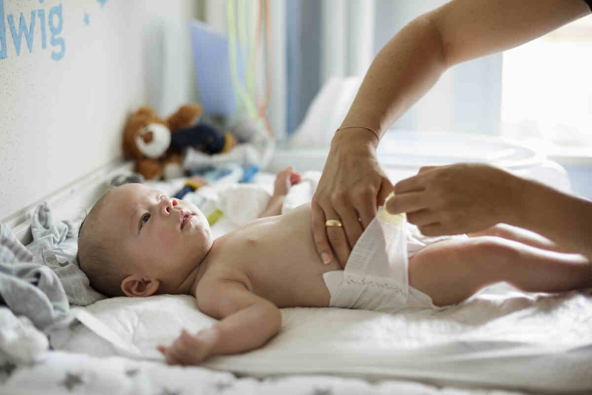 mother-changing-infant-diaper-infant-care
