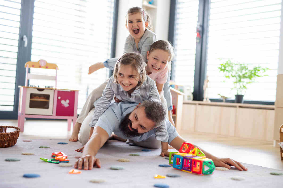father-with-three-daughters-indoors-exploring-parenting-tips