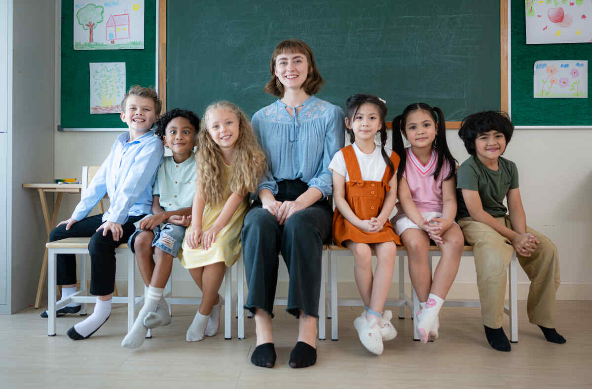 portrait-of-a-teacher-and-kids-in-a-classroom-kindergarten-preparation
