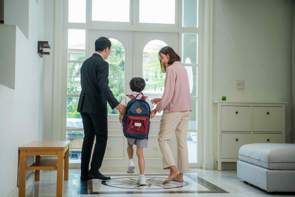 parents-helping-son-in-uniform-to-get-kindergarten-preparation