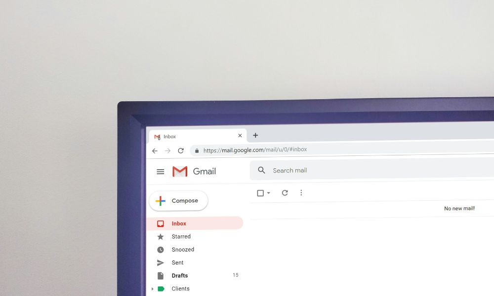 Zoomed-in photo of a Gmail inbox open on a desktop monitor, showing sidebar folders and empty message view Zoomed-in photo of a Gmail inbox open on a desktop monitor, showing sidebar folders and empty message view